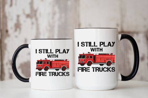 I Still Play With Fire Trucks Mug